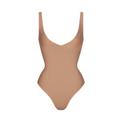 SKIMS BODY UNLINED PLUNGE THONG BODYSUIT | SIENNA